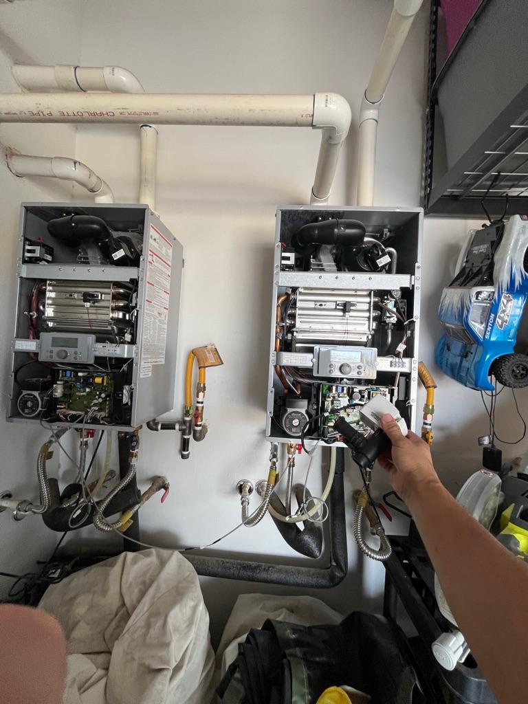 Focus Plumbing technician servicing dual tankless water heater units in Las Vegas